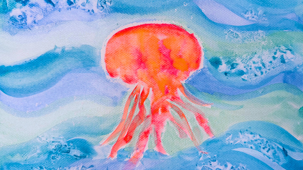 Colorful underwater jellyfish watercolor painting lesson for kids featuring crayon resist techniques and Saran Wrap texture effects. This ocean-themed art project teaches young artists watercolor painting skills, texture exploration, and mixed media techniques while creating a vibrant jellyfish artwork.