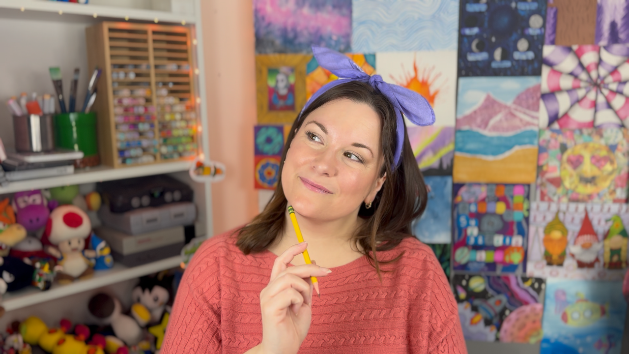 Ms. Jes standing in front of a display of art lessons created in Hello Homeschool Art